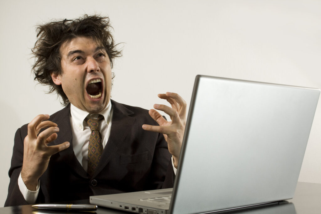 Crazy businessman frustrated with his computer